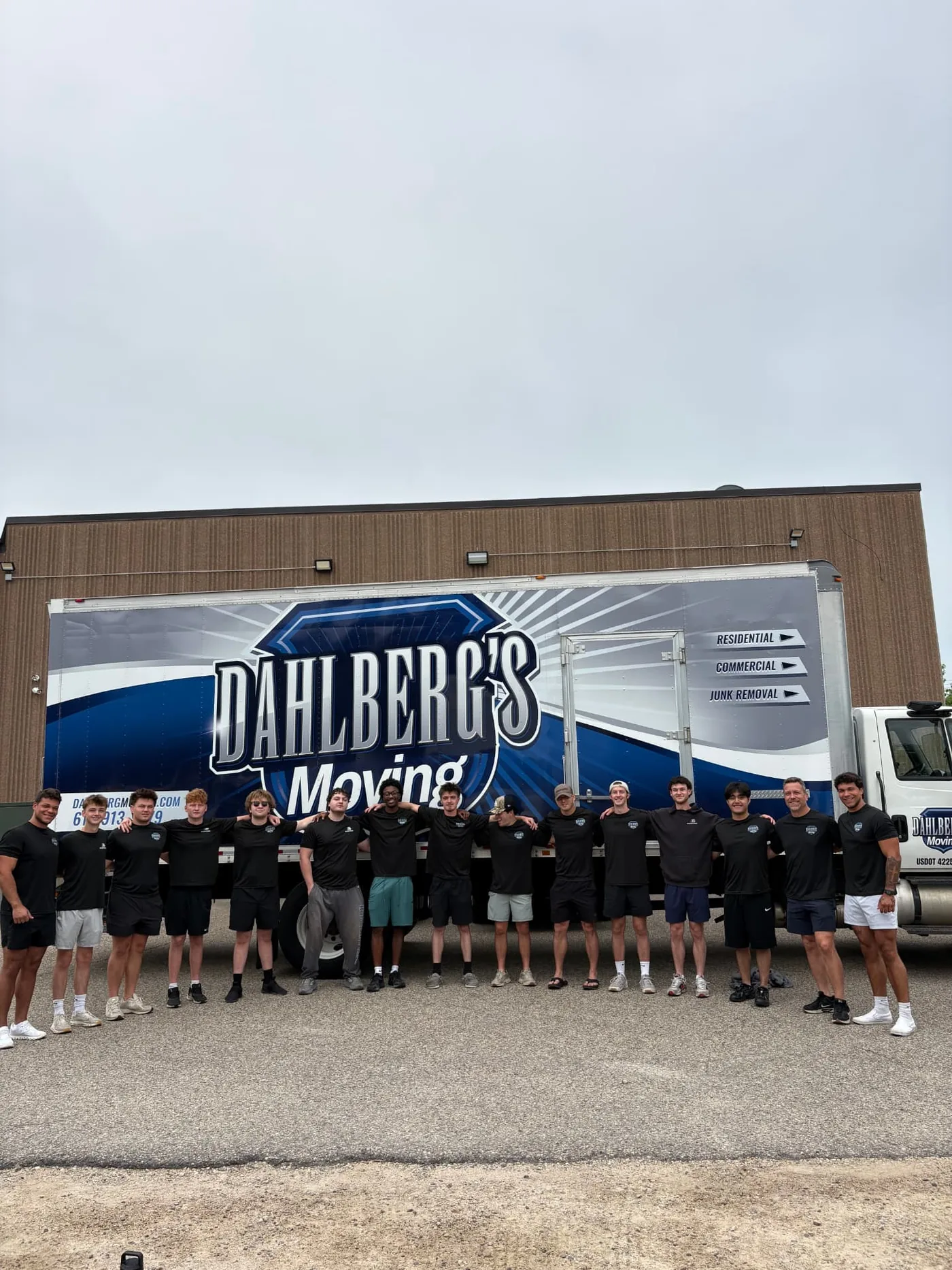 The Dahlberg's Moving crew of 18 professionals standing in front of their branded box truck